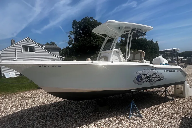 The Image of 2019 Key West 239 FS boat on gravel, featuring "Smokin' Fishermen" graphic. - 0