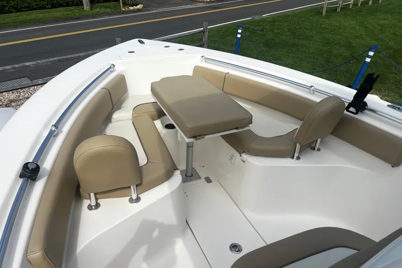 Slide: The Image of 2019 Key West 239 FS boat interior with beige seating and table setup. - 14