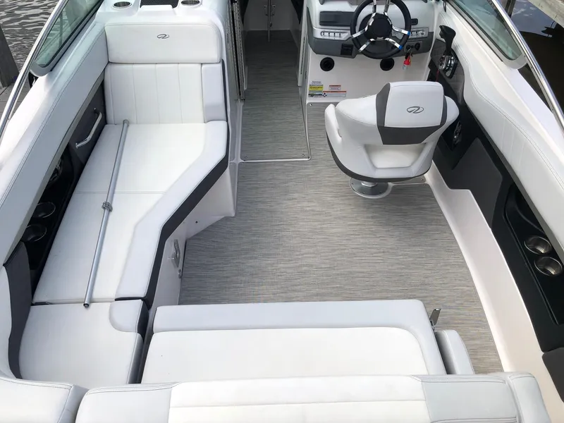 Slide: The Image of The image shows the cockpit of a 2014 Regal 24 FasDeck boat with white seating. - 13