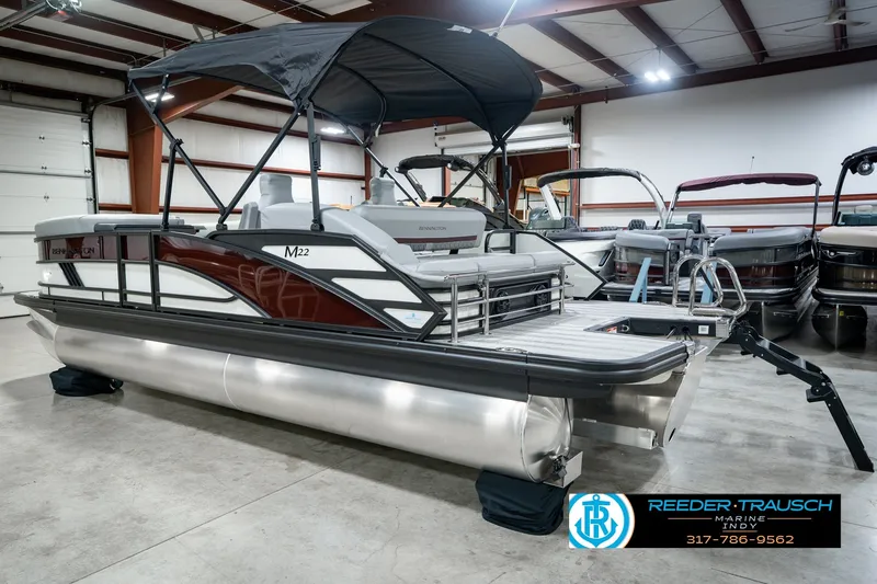 Slide: The Image of 2027 Bennington 22 MSB pontoon boat in showroom, featuring sleek design and modern amenities. - 10