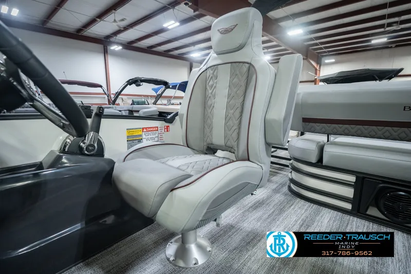 Slide: The Image of Captain's chair in a 2027 Bennington 22 MSB pontoon boat, showroom setting. - 47