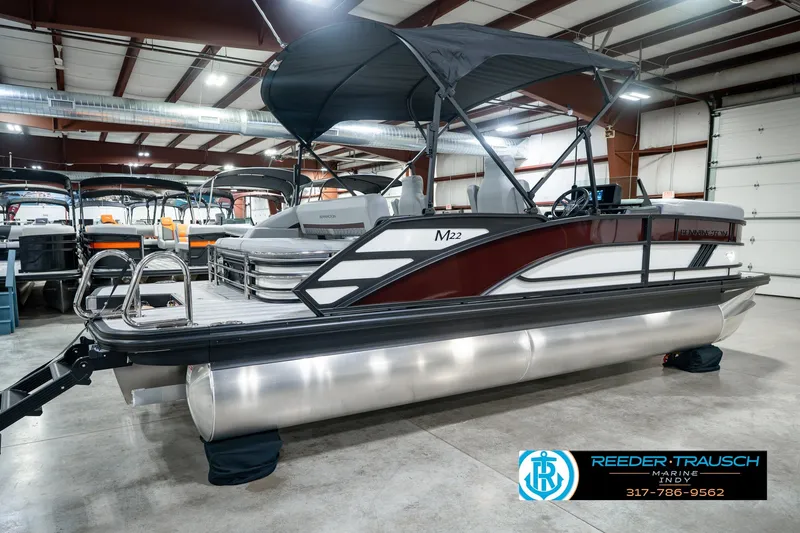 Slide: The Image of 2027 Bennington 22 MSB pontoon boat in showroom with canopy and sleek design. - 8