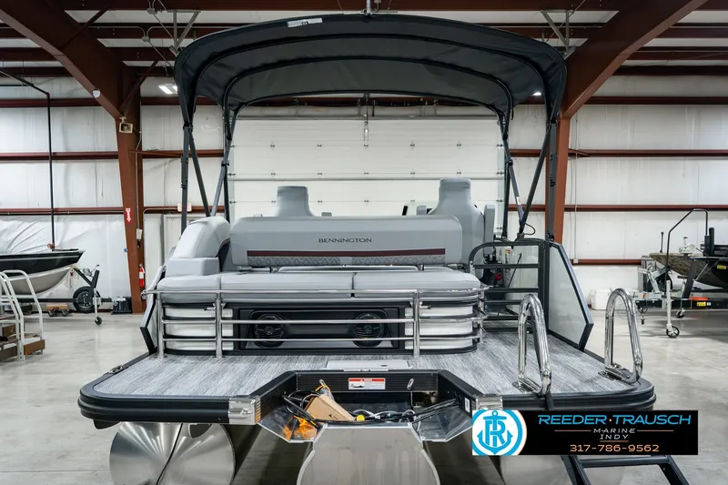 Slide: The Image of 2027 Bennington 22 MSB pontoon boat in a showroom, featuring sleek design and modern amenities. - 9