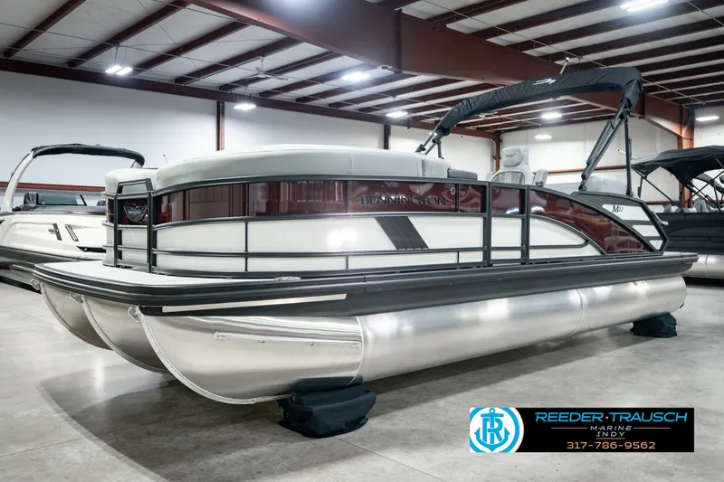 Slide: The Image of 2027 Bennington 22 MSB pontoon boat in showroom, featuring sleek design and modern amenities. - 1