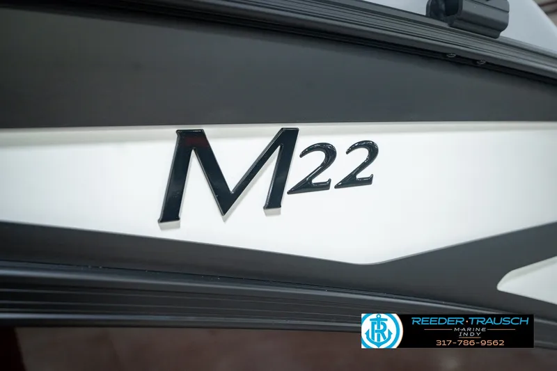 Slide: The Image of Close-up of 2027 Bennington 22 MSB boat model emblem with dealership logo. - 59