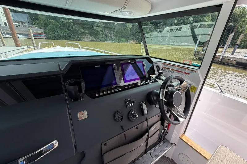 Slide: The Image of Interior view of 2025 Axopar 37 XC Cross Cabin boat cockpit with modern controls. - 16