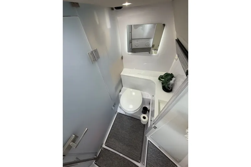 Slide: The Image of Modern bathroom interior of 2025 Axopar 37 XC Cross Cabin boat, featuring sleek design and amenities. - 26
