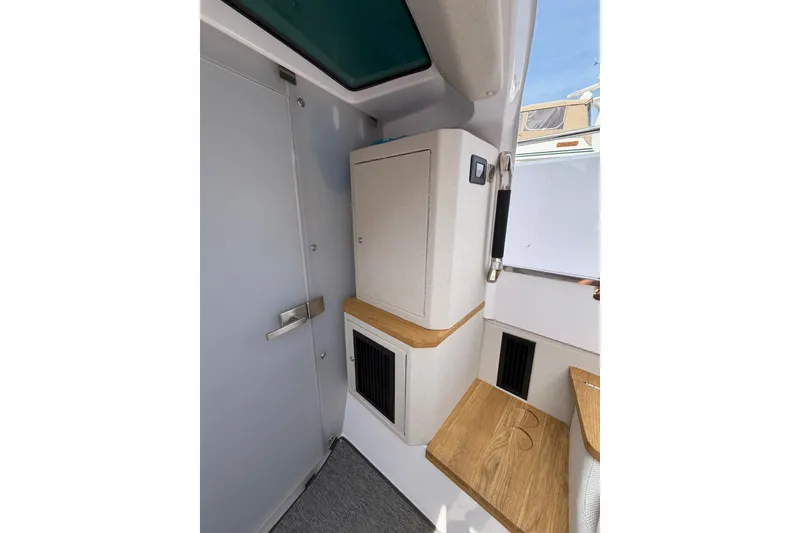 Slide: The Image of Interior of 2025 Axopar 37 XC Cross Cabin, featuring modern cabinetry and wood accents. - 22