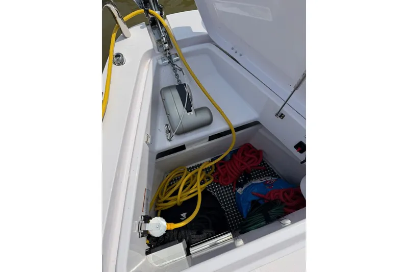 Slide: The Image of Storage compartment of 2025 Axopar 37 XC Cross Cabin with ropes and equipment. - 27