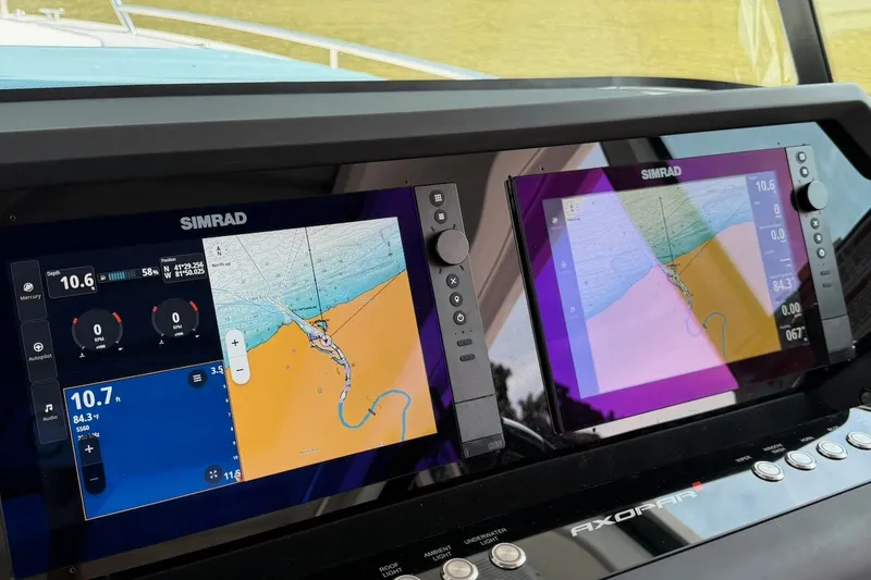 Slide: The Image of Simrad navigation displays on 2025 Axopar 37 XC Cross Cabin boat dashboard. - 17