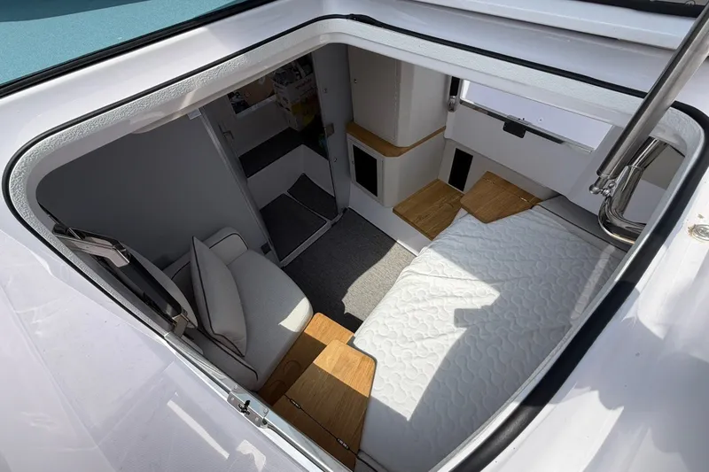 Slide: The Image of Interior view of 2025 Axopar 37 XC Cross Cabin, featuring cozy seating and modern design. - 19