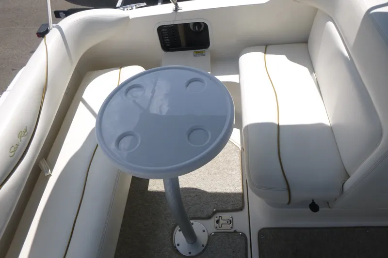 Slide: The Image of Interior seating area of a 2002 Sea Ray Sundancer 260 with a round table. - 18