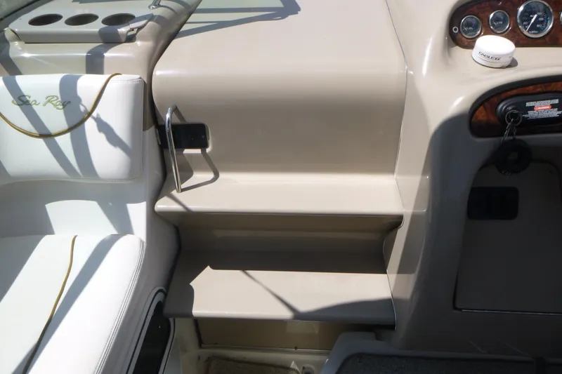 Slide: The Image of 2002 Sea Ray Sundancer 260 cockpit with beige seating and control panel. - 7