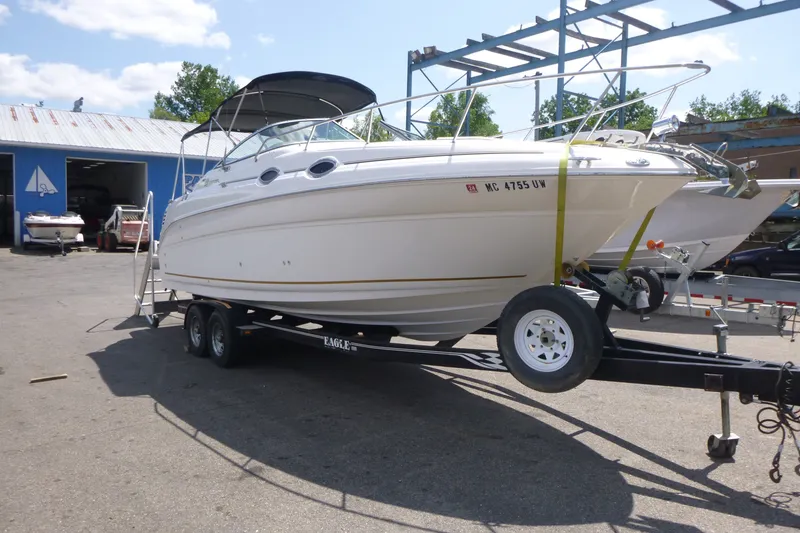 Slide: The Image of 2002 Sea Ray Sundancer 260 boat on trailer at marina, sunny day. - 3