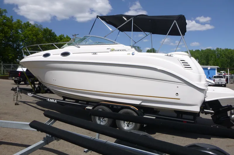 Slide: The Image of 2002 Sea Ray Sundancer 260 boat on trailer under blue sky. - 5