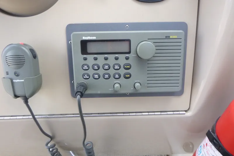 Slide: The Image of Raytheon marine radio system on 2002 Sea Ray Sundancer 260 boat dashboard. - 14