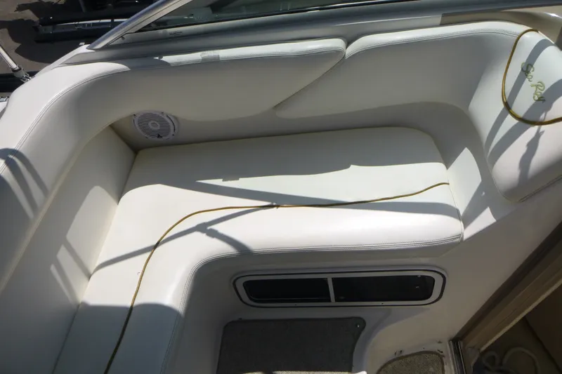 Slide: The Image of Interior seating of a 2002 Sea Ray Sundancer 260 boat, featuring white upholstery. - 16