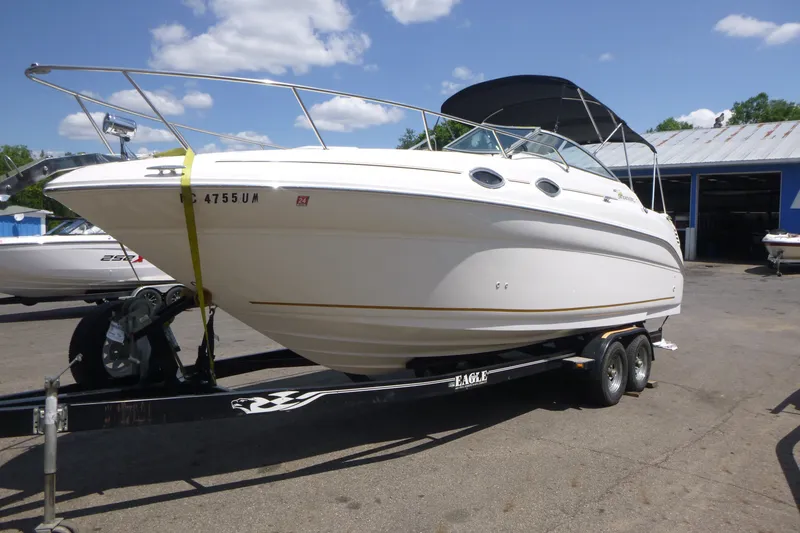 Slide: The Image of 2002 Sea Ray Sundancer 260 boat on trailer under clear blue sky. - 4