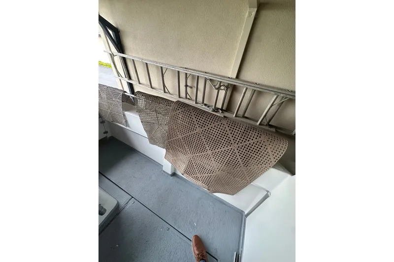 Slide: The Image of Interior of a 1999 Orca 24 boat with storage racks and floor mats. - 11
