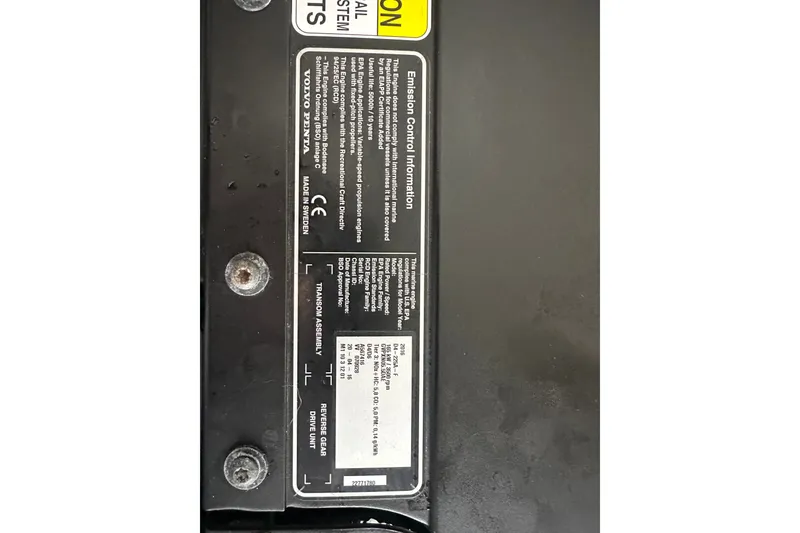 Slide: The Image of Label on Orca 24, 1999 model, showing emission control information and specifications. - 16