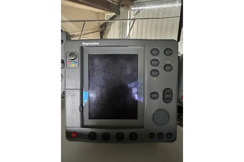 Slide: The Image of Raymarine Fishfinder L760 on 1999 Orca 24 boat, featuring a scratched display screen. - 24