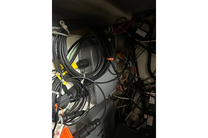 Slide: The Image of Tangled wires and cables inside a 1999 Orca 24 model. - 27