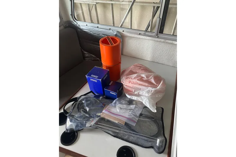 Slide: The Image of Boat interior with assorted equipment and supplies on a table, Orca 24, 1999 model. - 28