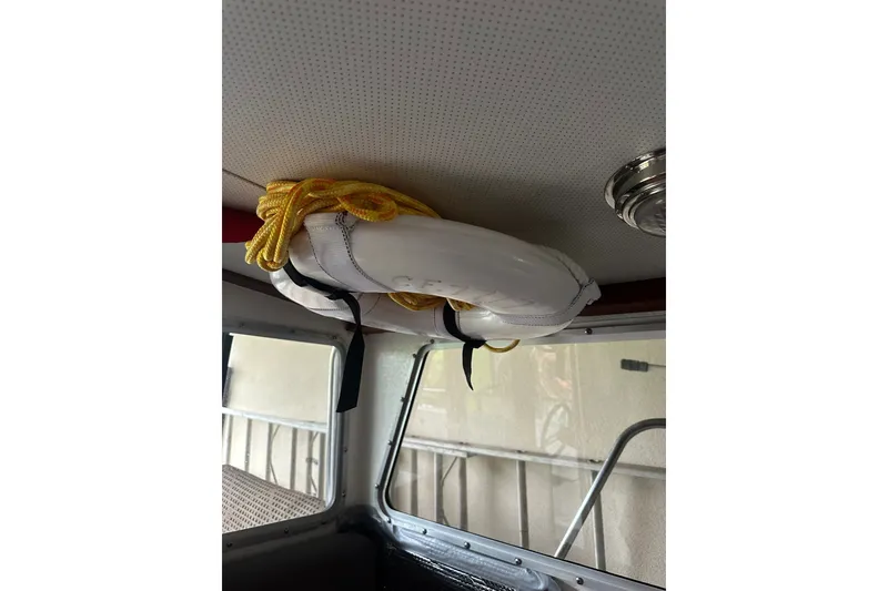 Slide: The Image of Interior of a 1999 Orca 24 boat with a life preserver and yellow rope. - 32