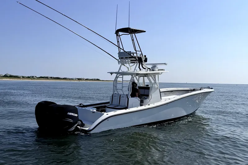 Slide: The Image of 2008 Yellowfin 36 Offshore boat on calm water, equipped with Mercury engines. - 3