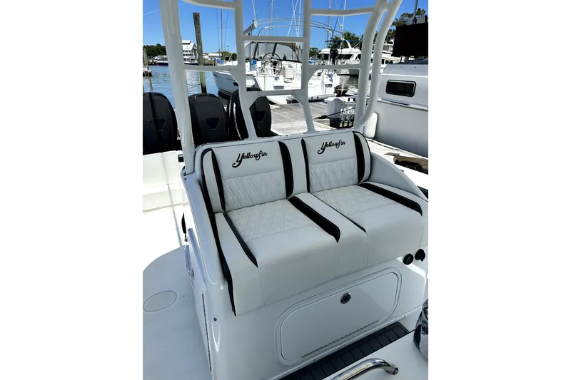 Slide: The Image of 2008 Yellowfin 36 Offshore boat with white cushioned seating at a marina. - 12