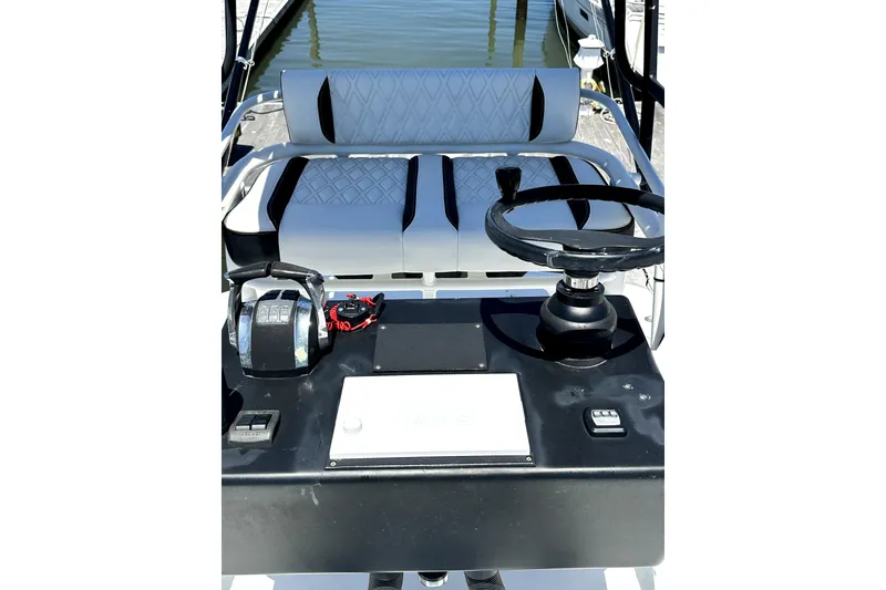 Slide: The Image of 2008 Yellowfin 36 Offshore boat helm with steering wheel and controls, docked by water. - 20