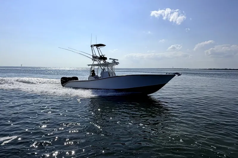 Slide: The Image of 2008 Yellowfin 36 Offshore boat cruising on open water under a clear sky. - 0