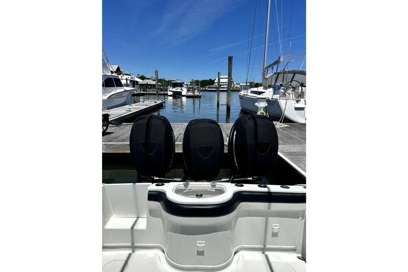 Slide: The Image of 2008 Yellowfin 36 Offshore boat with triple outboard engines docked at a marina. - 23