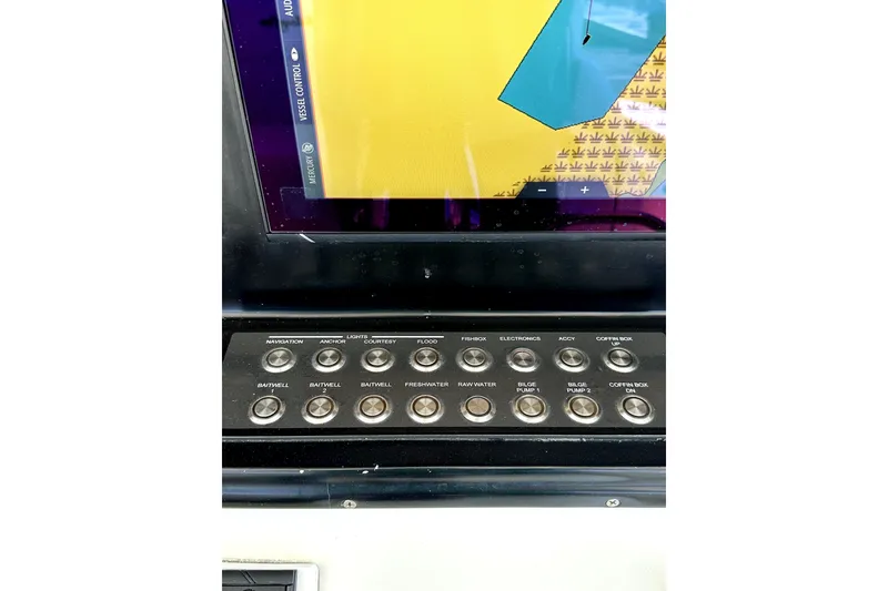 Slide: The Image of Control panel of a 2008 Yellowfin 36 Offshore boat with various labeled buttons. - 14