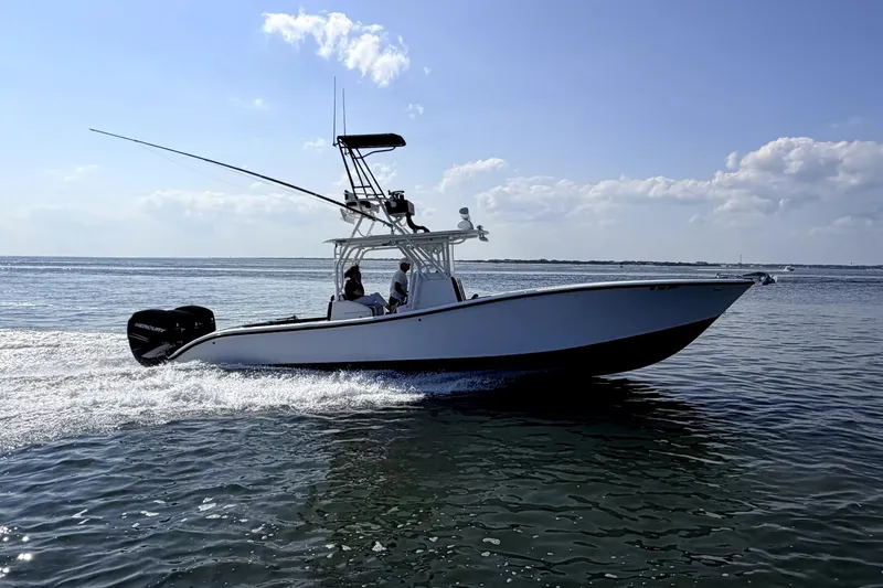 Slide: The Image of 2008 Yellowfin 36 Offshore boat cruising on open water under a clear blue sky. - 4