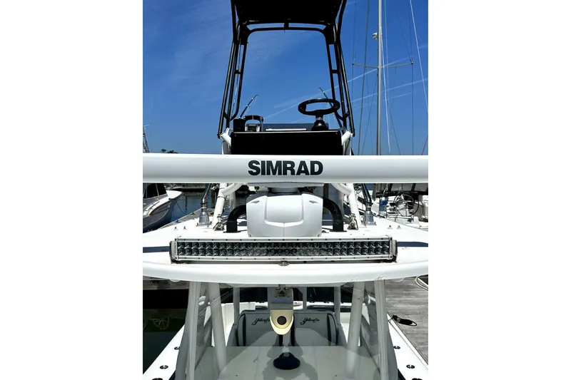 Slide: The Image of 2008 Yellowfin 36 Offshore boat with Simrad equipment, docked under clear blue sky. - 18
