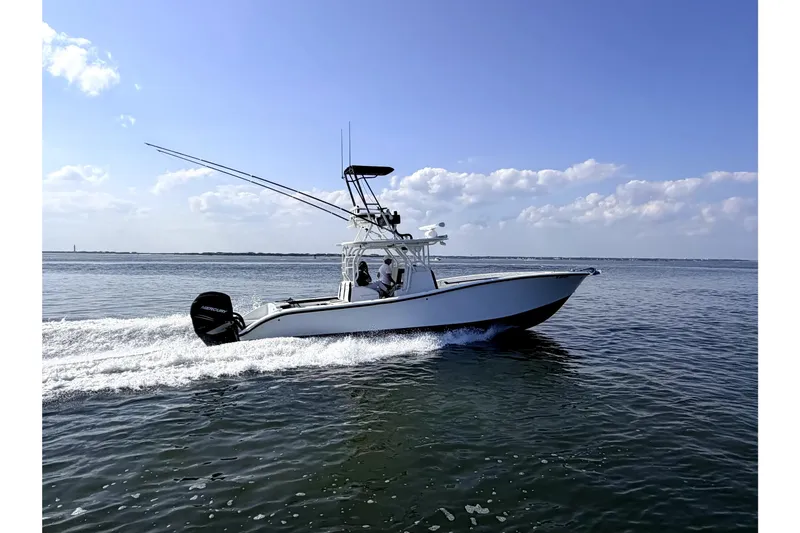 Slide: The Image of 2008 Yellowfin 36 Offshore boat cruising on open water under a clear blue sky. - 2