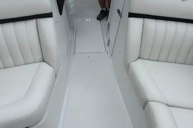 Slide: The Image of 2016 Cobalt A28 boat interior with white leather seating and sleek design. - 41