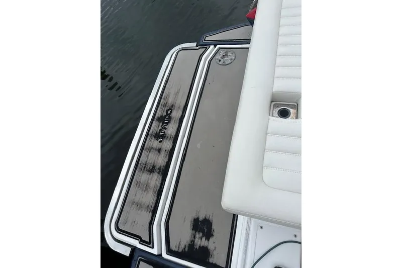 Slide: The Image of 2016 Cobalt A28 boat swim platform with white seating and water backdrop. - 36