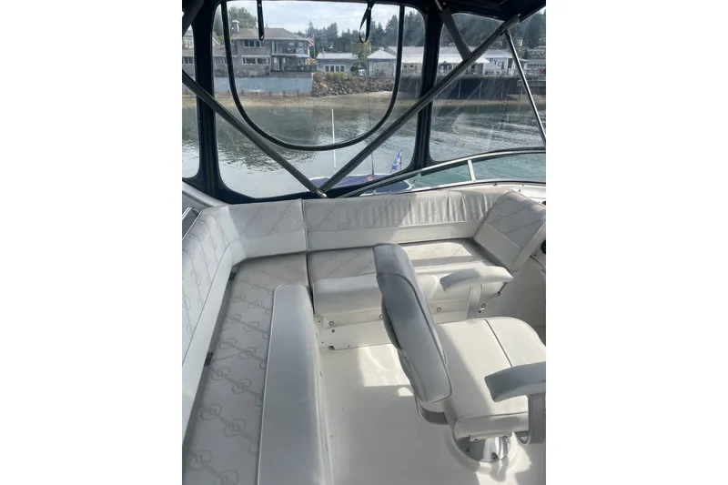 Slide: The Image of 1999 Bayliner 4087 Aft Cabin Motoryacht interior with white seating and waterfront view. - 11