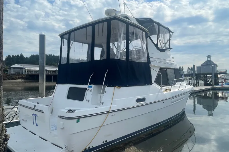 Slide: The Image of 1999 Bayliner 4087 Aft Cabin Motoryacht docked at marina under cloudy sky. - 2