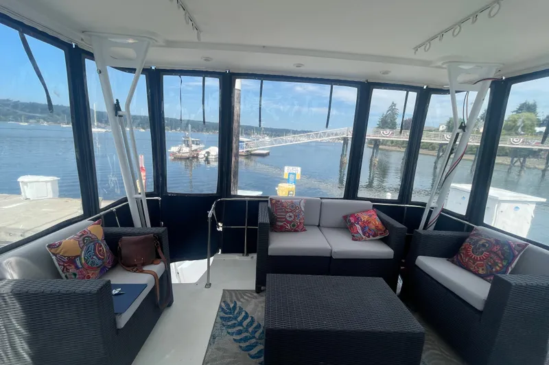 Slide: The Image of 1999 Bayliner 4087 Aft Cabin Motoryacht interior with comfortable seating and waterfront view. - 5