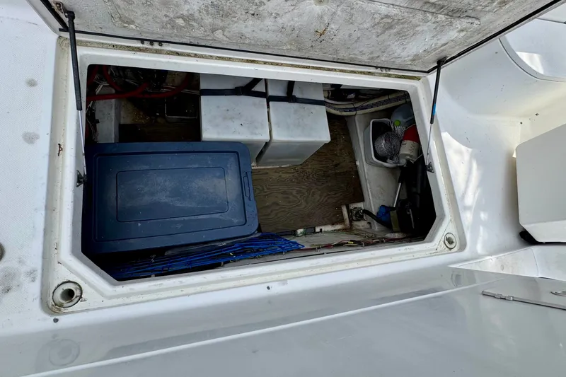 Slide: The Image of 1999 Bayliner 4087 Aft Cabin Motoryacht storage compartment with containers and equipment. - 42