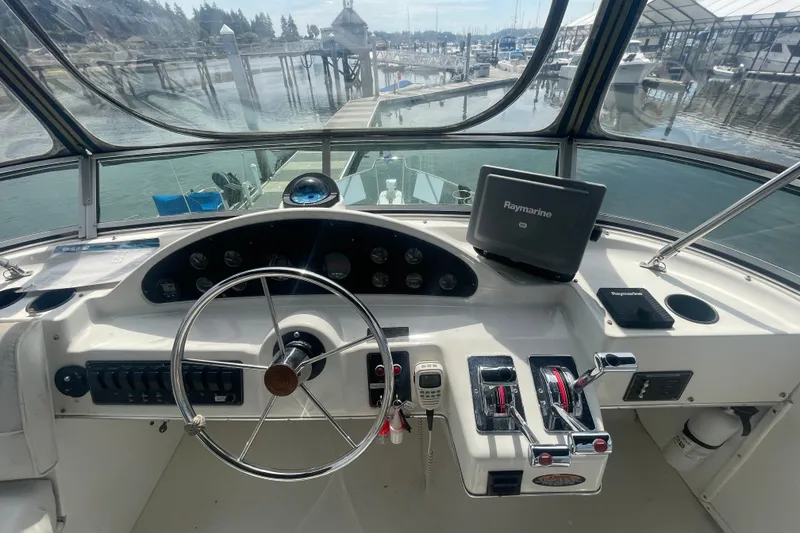 Slide: The Image of 1999 Bayliner 4087 Aft Cabin Motoryacht helm with steering wheel and navigation equipment. - 8