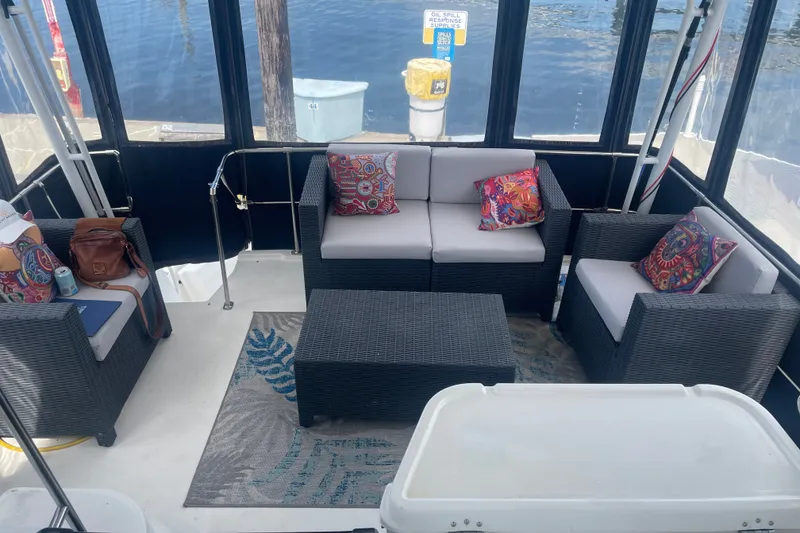 Slide: The Image of 1999 Bayliner 4087 Aft Cabin Motoryacht interior with wicker seating and colorful cushions. - 12