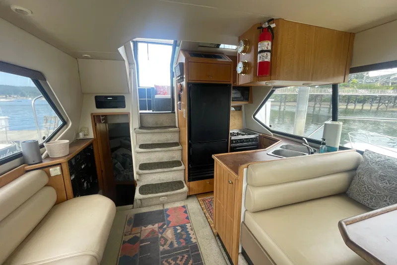 Slide: The Image of Interior of 1999 Bayliner 4087 Aft Cabin Motoryacht with cozy seating and kitchenette. - 18