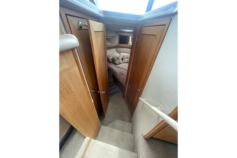 Slide: The Image of Interior view of 1999 Bayliner 4087 Aft Cabin Motoryacht with wooden doors and cozy bedroom. - 23