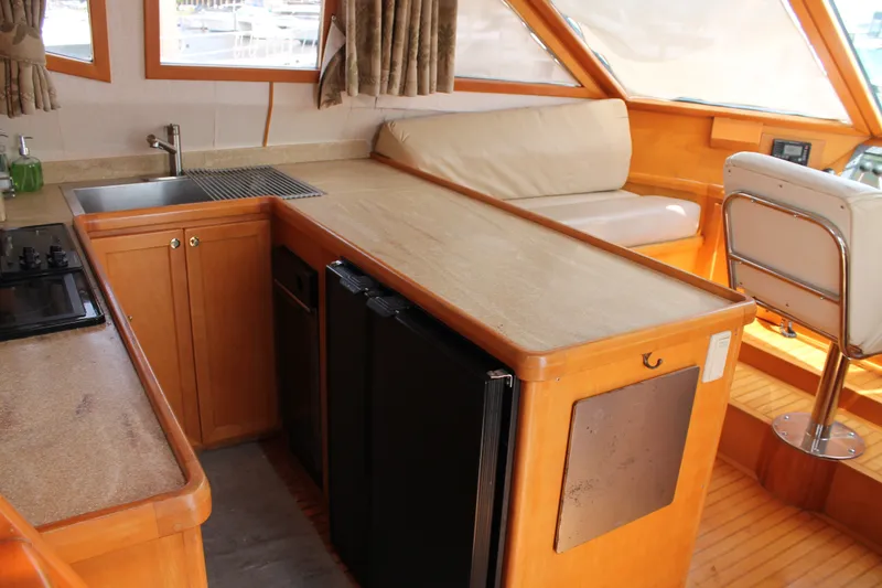 Slide: The Image of Interior of 1997 McKinna 48 Pilothouse yacht with kitchen and seating area. - 17