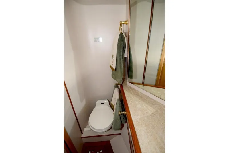Slide: The Image of Bathroom interior of 1997 McKinna 48 Pilothouse yacht with toilet and mirrored cabinet. - 34
