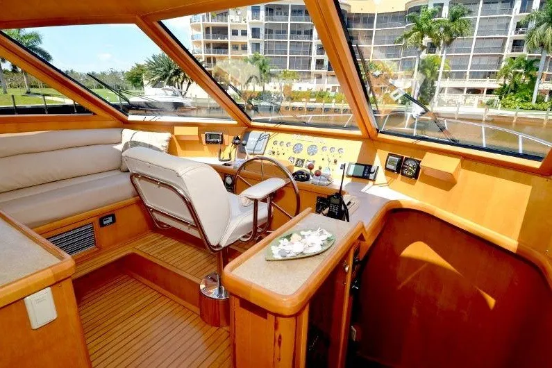 Slide: The Image of Luxurious 1997 McKinna 48 Pilothouse interior with elegant wood finish and modern navigation equipment. - 19